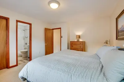 a bedroom with a large bed and a bathroom at 2 Mi to Frisco Ski Hill Mountain Home with Hot Tub! in Frisco