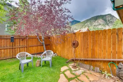 a backyard with two chairs and a fence at 2 Mi to Frisco Ski Hill Mountain Home with Hot Tub! in Frisco