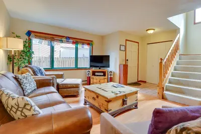 a living room with a couch and a table at 2 Mi to Frisco Ski Hill Mountain Home with Hot Tub! in Frisco