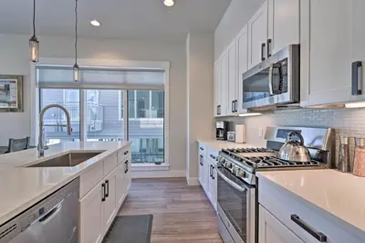a kitchen with a sink and a stove top oven at Downtown Winter Park Condo - 3 Miles to Ski Resort in Winter Park