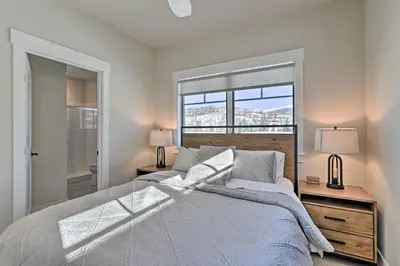 a bedroom with a large bed and a window at Downtown Winter Park Condo - 3 Miles to Ski Resort in Winter Park