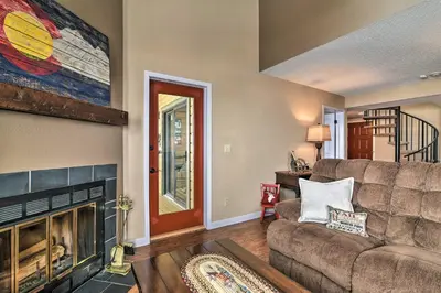 a living room with a couch and a fireplace at Walk to Ski Lift Mtn-View Granby Ranch Condo in Granby