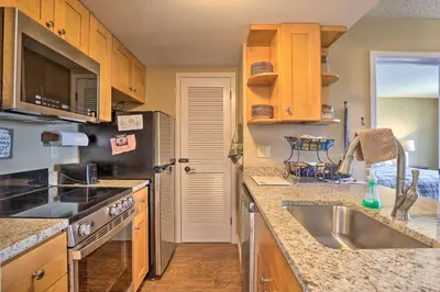 a kitchen with a sink and a stove top oven at Walk to Ski Lift Mtn-View Granby Ranch Condo in Granby