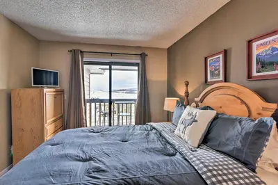 a bedroom with a bed and a large window at Walk to Ski Lift Mtn-View Granby Ranch Condo in Granby