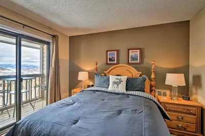 a bedroom with a bed and a large window at Walk to Ski Lift Mtn-View Granby Ranch Condo in Granby