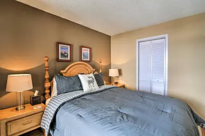 a bedroom with a bed and two lamps and a window at Walk to Ski Lift Mtn-View Granby Ranch Condo in Granby