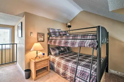 a bedroom with two bunk beds in a house at Walk to Ski Lift Mtn-View Granby Ranch Condo in Granby