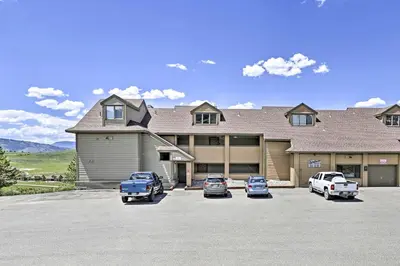 a large house with cars parked in a parking lot at Walk to Ski Lift Mtn-View Granby Ranch Condo in Granby