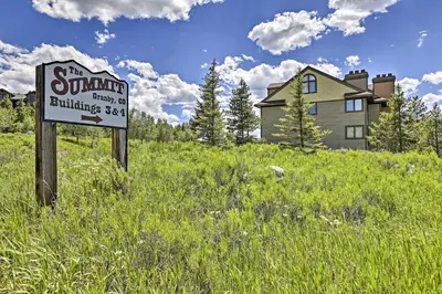 a sign in a field in front of a house at Walk to Ski Lift Mtn-View Granby Ranch Condo in Granby
