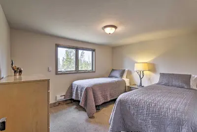 a bedroom with two beds and a window at Updated Cabin with Hot Tub about 11 Mi to Winter Park! in Tabernash