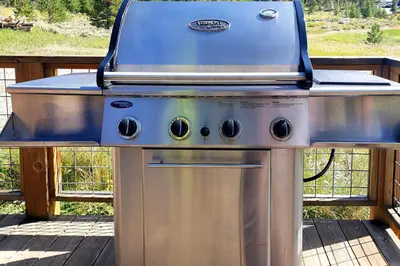 a grill sitting on top of a deck at Updated Cabin with Hot Tub about 11 Mi to Winter Park! in Tabernash