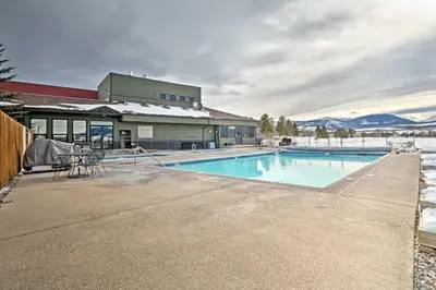 a swimming pool in front of a building at Eat, Sleep, Ski! Rustic Mtn Condo WiFi,TV, HotTub in Fraser