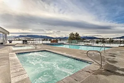 a swimming pool with a view of the mountains at Eat, Sleep, Ski! Rustic Mtn Condo WiFi,TV, HotTub in Fraser