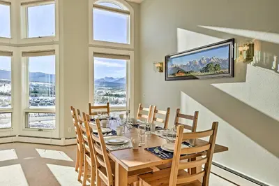 a dining room with a table with chairs and windows at Gorgeous Townhome with Fraser Valley Mountain Views! in Fraser