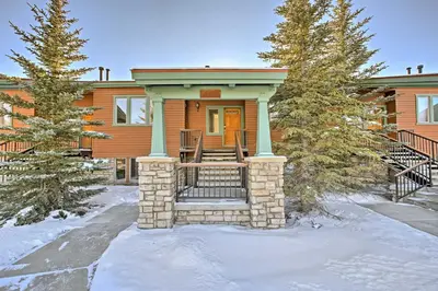 a house with a front porch in the snow at Gorgeous Townhome with Fraser Valley Mountain Views! in Fraser