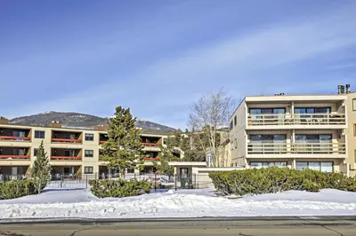 an apartment building with snow in front of it at Mtn-View Condo with Hot Tub Access in Dillon! in Dillon
