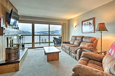 a living room with a couch and a large window at Mtn-View Condo with Hot Tub Access in Dillon! in Dillon