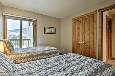 a bedroom with two beds and a window at Mtn-View Condo with Hot Tub Access in Dillon! in Dillon