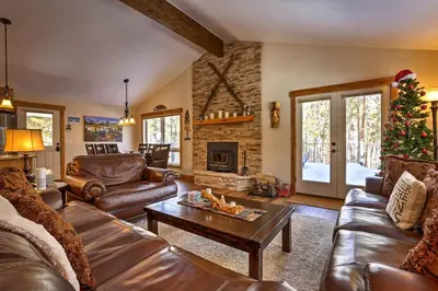 a living room with leather furniture and a christmas tree at Hot Tub! Family Gem on Snake River in Keystone! in Keystone
