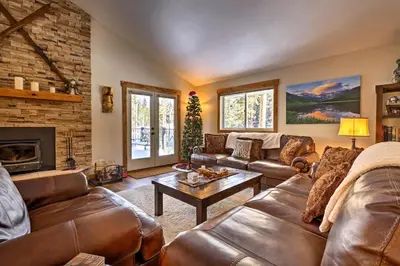a living room with leather furniture and a fireplace at Hot Tub! Family Gem on Snake River in Keystone! in Keystone