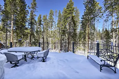 a patio with a table and chairs in the snow at Hot Tub! Family Gem on Snake River in Keystone! in Keystone