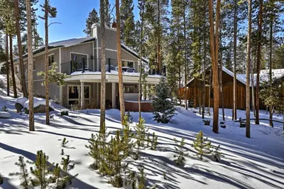 a house in the woods in the snow at Hot Tub! Family Gem on Snake River in Keystone! in Keystone