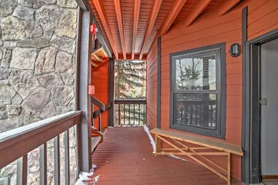 a wooden walkway to a house with a window at Walk to Main St Condo with Deck in Frisco in Frisco