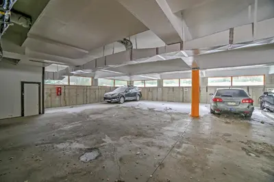 an empty parking garage with two cars parked in it at Walk to Main St Condo with Deck in Frisco in Frisco