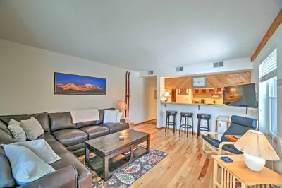 a living room with a couch and a table at Walk to Main St Condo with Deck in Frisco in Frisco