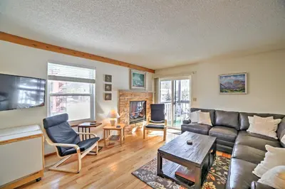 a living room with a couch and a table at Walk to Main St Condo with Deck in Frisco in Frisco