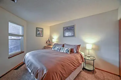 a bedroom with a large bed and a window at Walk to Main St Condo with Deck in Frisco in Frisco