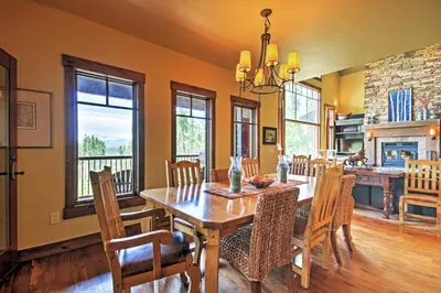 a kitchen and dining room with a wooden table and chairs at Tabernash Retreat with Hot Tub and Stunning Mtn Views! in Tabernash