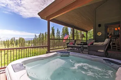 a hot tub on the deck of a house at Tabernash Retreat with Hot Tub and Stunning Mtn Views! in Tabernash