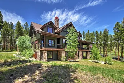 a home in the woods with a tree at Tabernash Retreat with Hot Tub and Stunning Mtn Views! in Tabernash