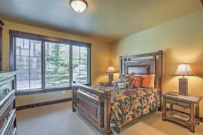 a bedroom with a large bed and a window at Lavish Fraser Townhome with Deck and Mountain Views! in Fraser
