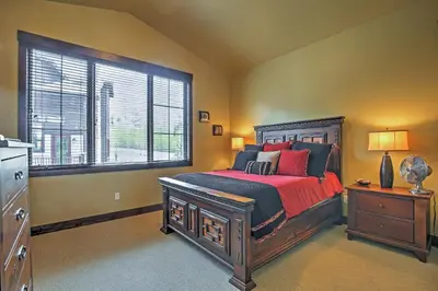 a bedroom with a large bed and a window at Lavish Fraser Townhome with Deck and Mountain Views! in Fraser
