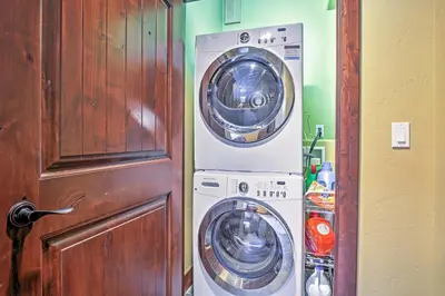 a washer and dryer in a room next to a door at Lavish Fraser Townhome with Deck and Mountain Views! in Fraser