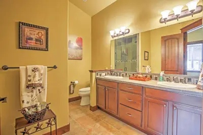 a bathroom with a double sink and a toilet at Lavish Fraser Townhome with Deck and Mountain Views! in Fraser