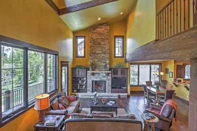 a large living room with a fireplace and a couch at Lavish Fraser Townhome with Deck and Mountain Views! in Fraser