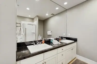 a bathroom with two sinks and a large mirror at Base Camp One 112 in Granby