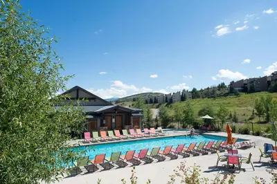 a swimming pool with lounge chairs and a resort at Base Camp One 112 in Granby