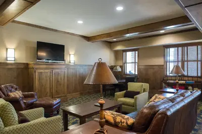 a living room with leather furniture and a flat screen tv at Base Camp One 112 in Granby