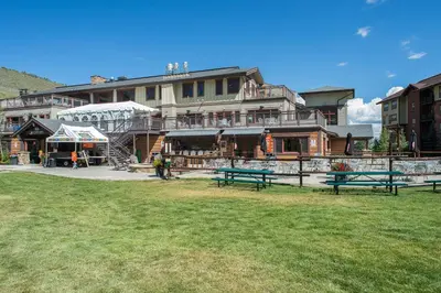 a large building with benches in front of it at Base Camp One 112 in Granby