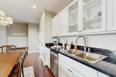 a kitchen with white cabinets and a sink at Base Camp One 112 in Granby