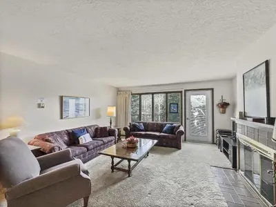 a living room with two couches and a fireplace at CC43 Chateau Claire condo in Dillon