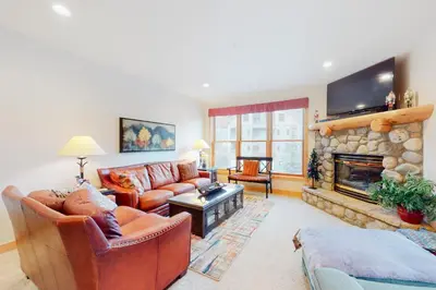 a living room with a couch and a fireplace at Mill Creek #203 in Keystone