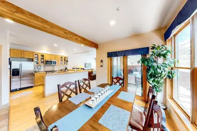 a kitchen and dining room with a table and chairs at Mill Creek #203 in Keystone