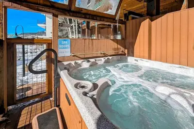 a jacuzzi tub in a room with a window at Mill Creek #203 in Keystone