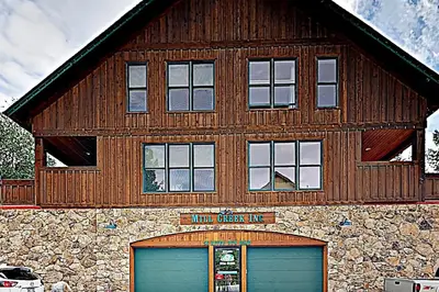 a large wooden building with two garage doors in front at Mill Creek #203 in Keystone