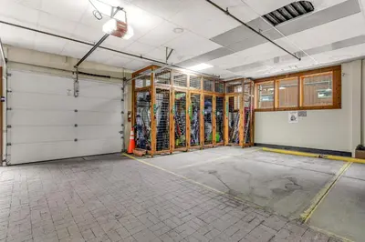 an empty room with two garage doors and scaffolding at Mill Creek #203 in Keystone